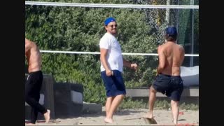 Leonardo DiCaprio playing volleyball in Malibu's Beach with friends